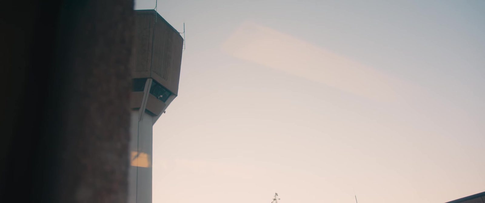 Watchtower against the evening sky – still from Let It Out – Rap Music in Prison